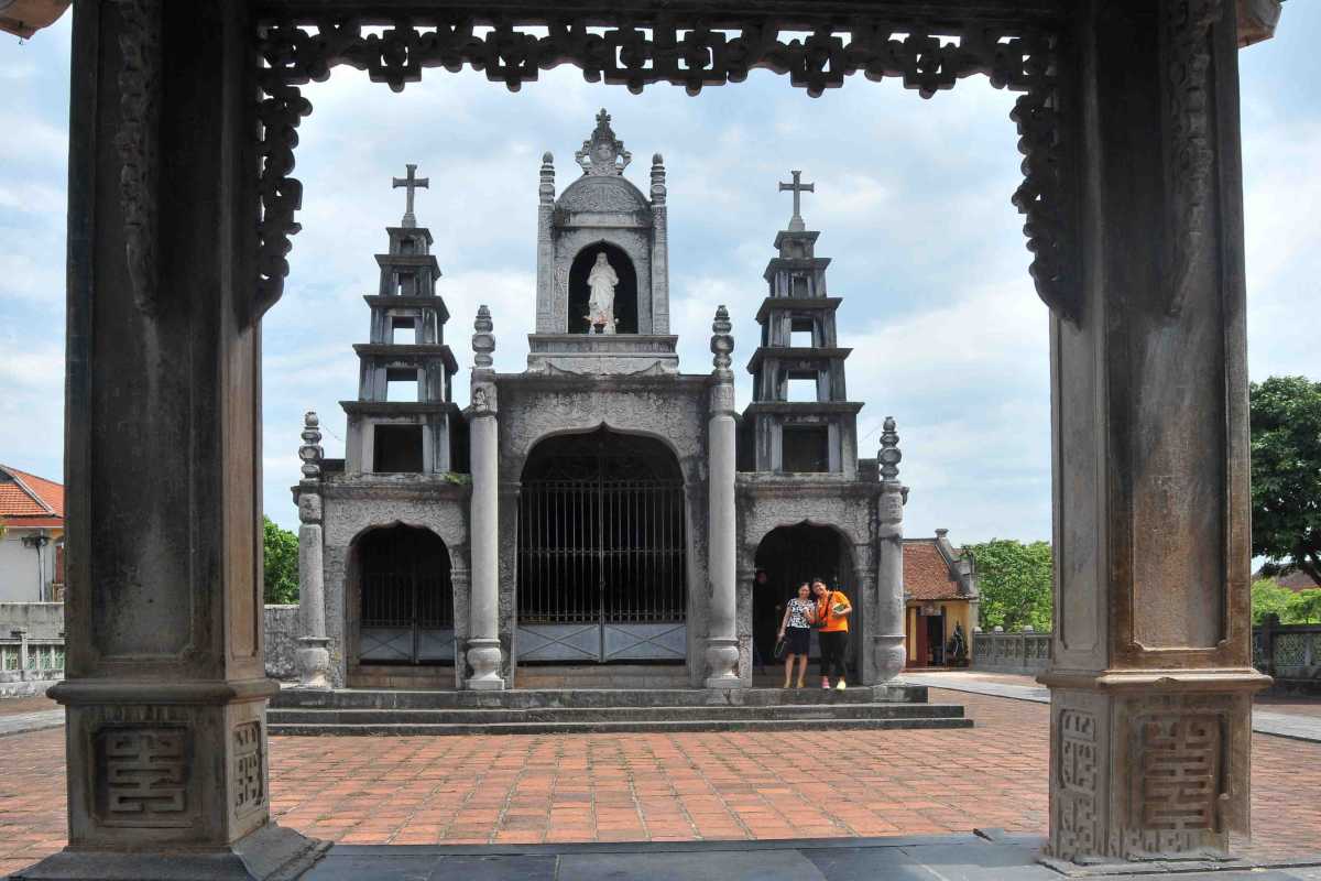 Phat Diem Cathedral Ninh Binh main altar and shrine Phat Diem Cathedral Ninh Binh features the main altar, stone pillars, and ornate shrine inside the historic cathedral interior.