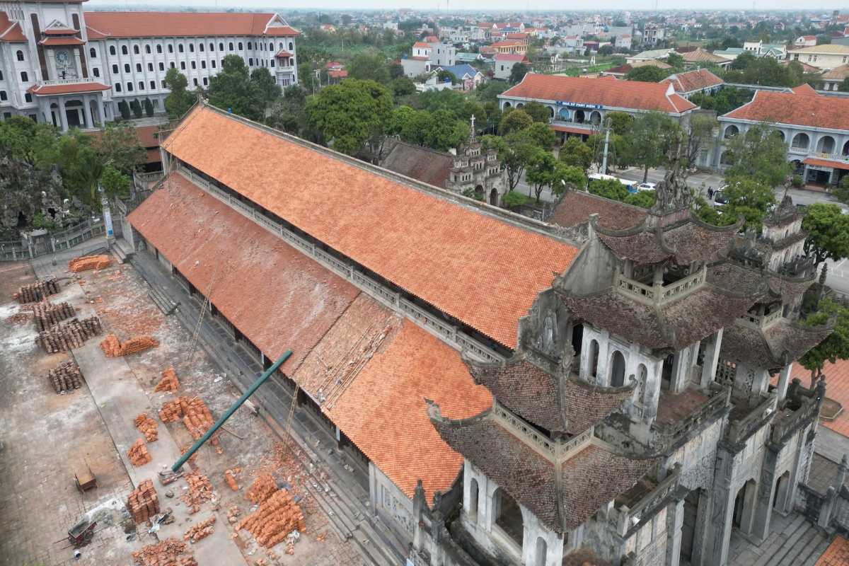 Phat Diem Cathedral Ninh Binh stone church and red-tiled roof Phat Diem Cathedral Ninh Binh stone church with long red-tiled roof and restoration area in view