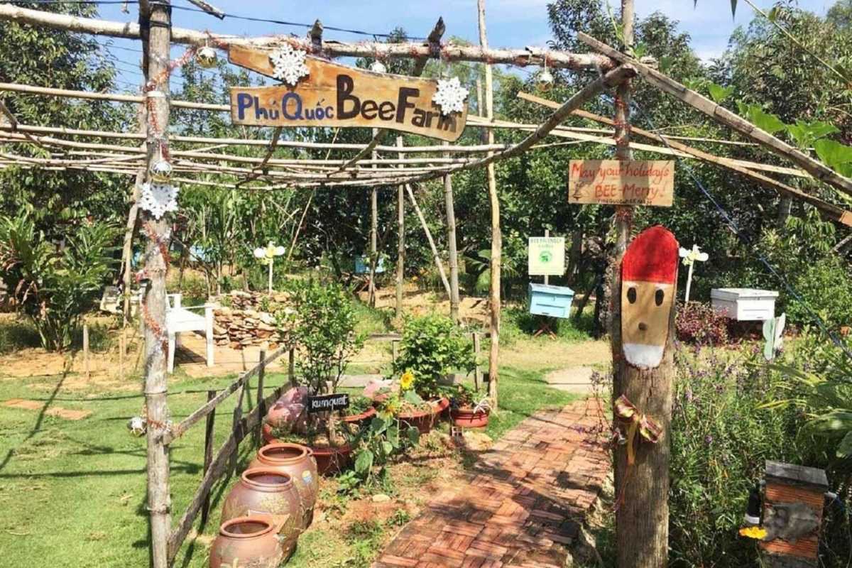 Family visitors wearing hats and holding honeycomb at Phu Quoc Bee Farm Happy family enjoying hands-on honeycomb experience at Phu Quoc Bee Farm