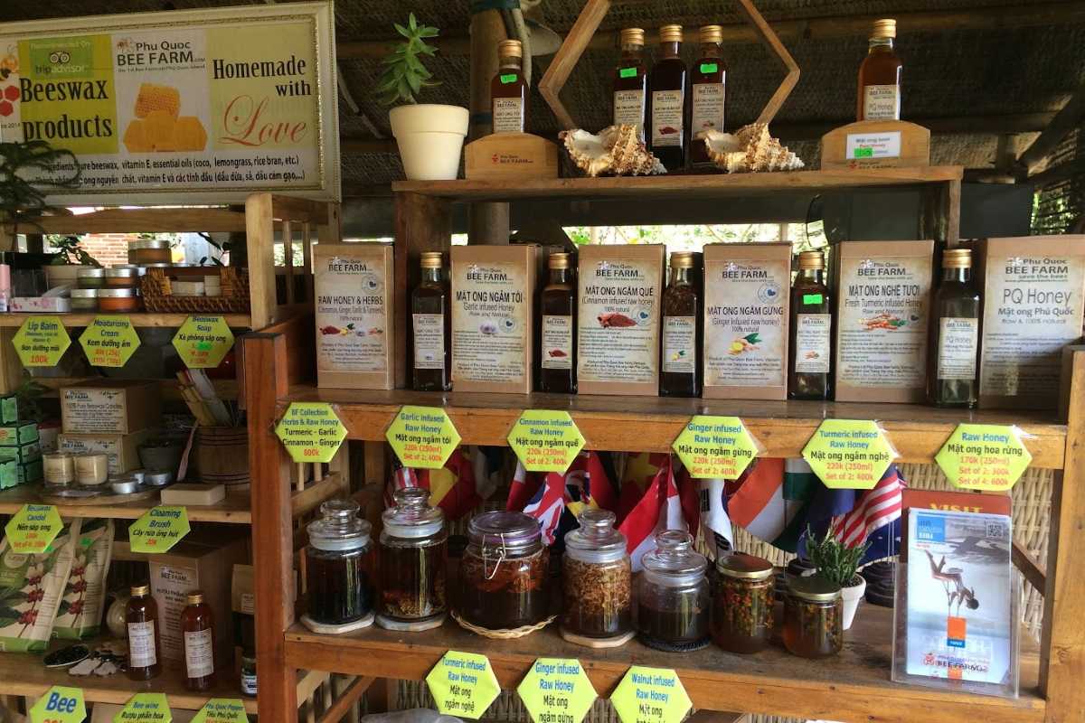 Honey and beeswax products displayed at Phu Quoc Bee Farm, including various infused honey bottles and skincare items