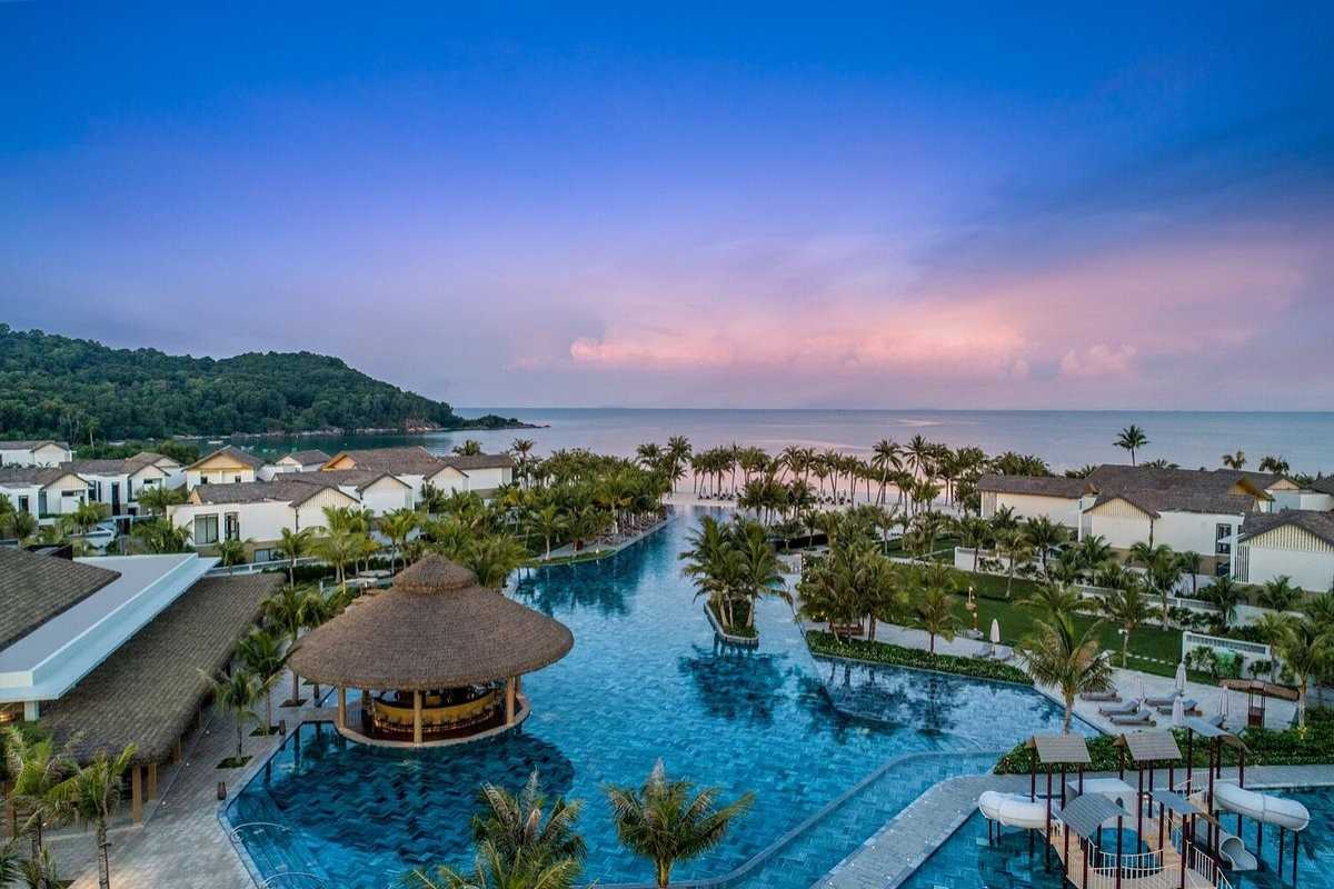 Aerial View of Tropical Island near Phu Quoc Island Aerial shot of lush green tropical island surrounded by deep blue waters near Phu Quoc Island.