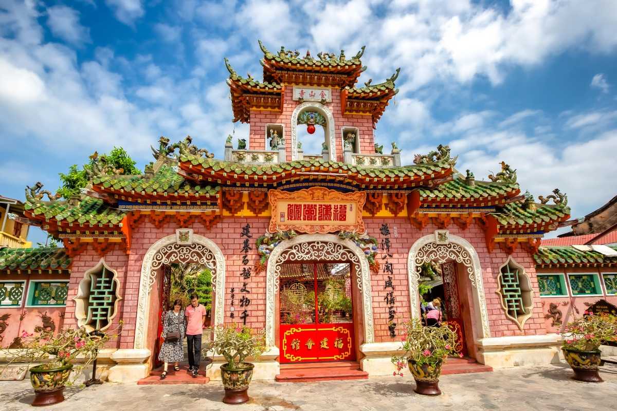 Ornate Pink Facade of Cantonese Assembly Hall Hoi An Ornate pink facade with traditional roof and decorative arches at Cantonese Assembly Hall Hoi An