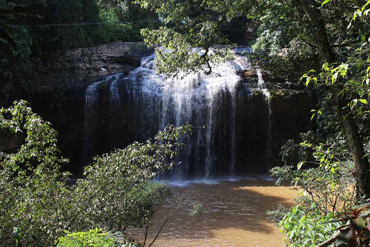 Prenn Waterfall Da Lat cable car above waterfall Prenn Waterfall Da Lat with a red cable car hovering over the cascading waterfall in Da Lat.
