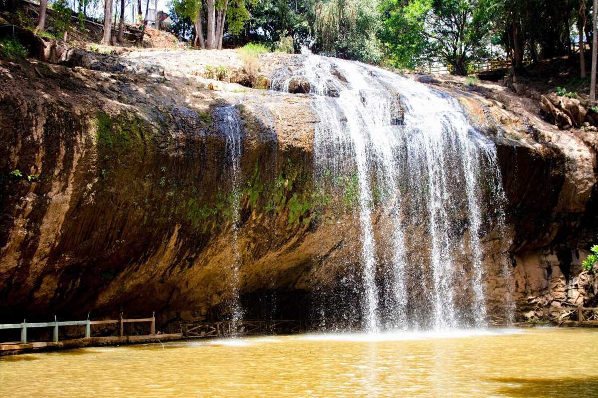 Prenn Waterfall Da Lat entrance with signage Prenn Waterfall Da Lat entrance marked by a stone with yellow