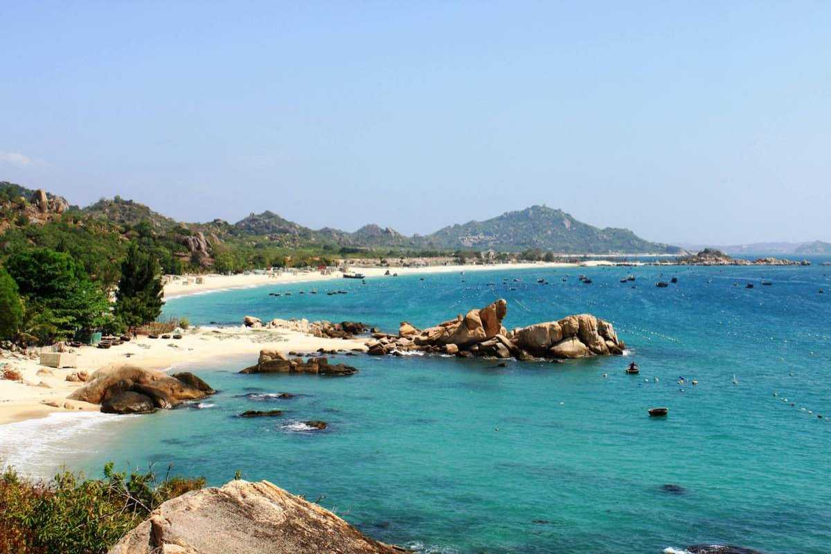 Pristine Coastal Waters of Nha Phu Lagoon Nha Trang Pristine turquoise coastal waters at Nha Phu Lagoon Nha Trang with rocky shoreline and clear skies