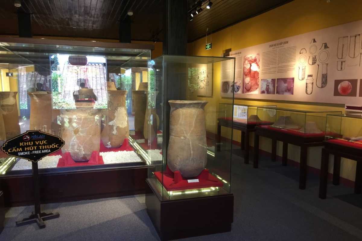 Sa Huynh Funerary Jar in Protected Glass Case Large Sa Huynh funerary jar displayed in a secure glass case at the Museum of Sa Huynh Culture
