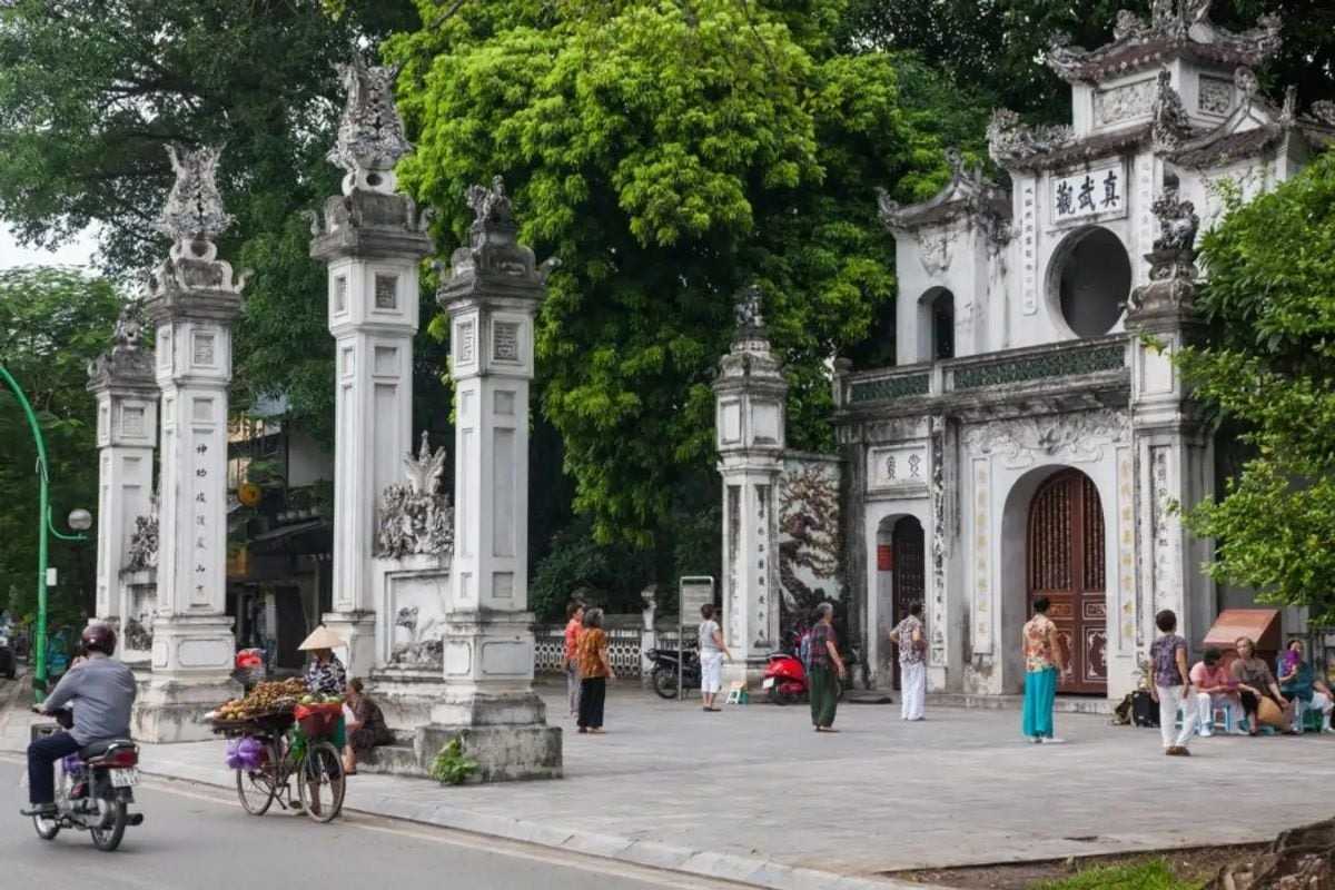 Quan Thanh Temple Courtyard with Visitors Courtyard of Quan Thanh Temple with visitors admiring the garden and architecture