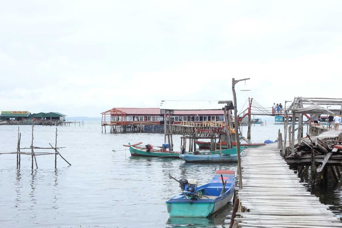 Traditional Fishing Pier with Boats at Dusk Traditional fishing pier and moored boats during dusk at Rach Vem Fishing Village, Phu Quoc