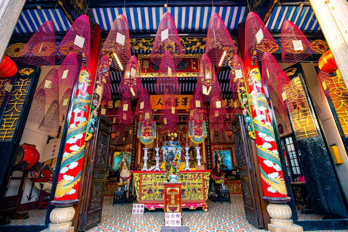 Red Incense Lanterns Hanging in Cantonese Assembly Hall Numerous red incense spiral lanterns hanging from ceiling inside Cantonese Assembly Hall Hoi An