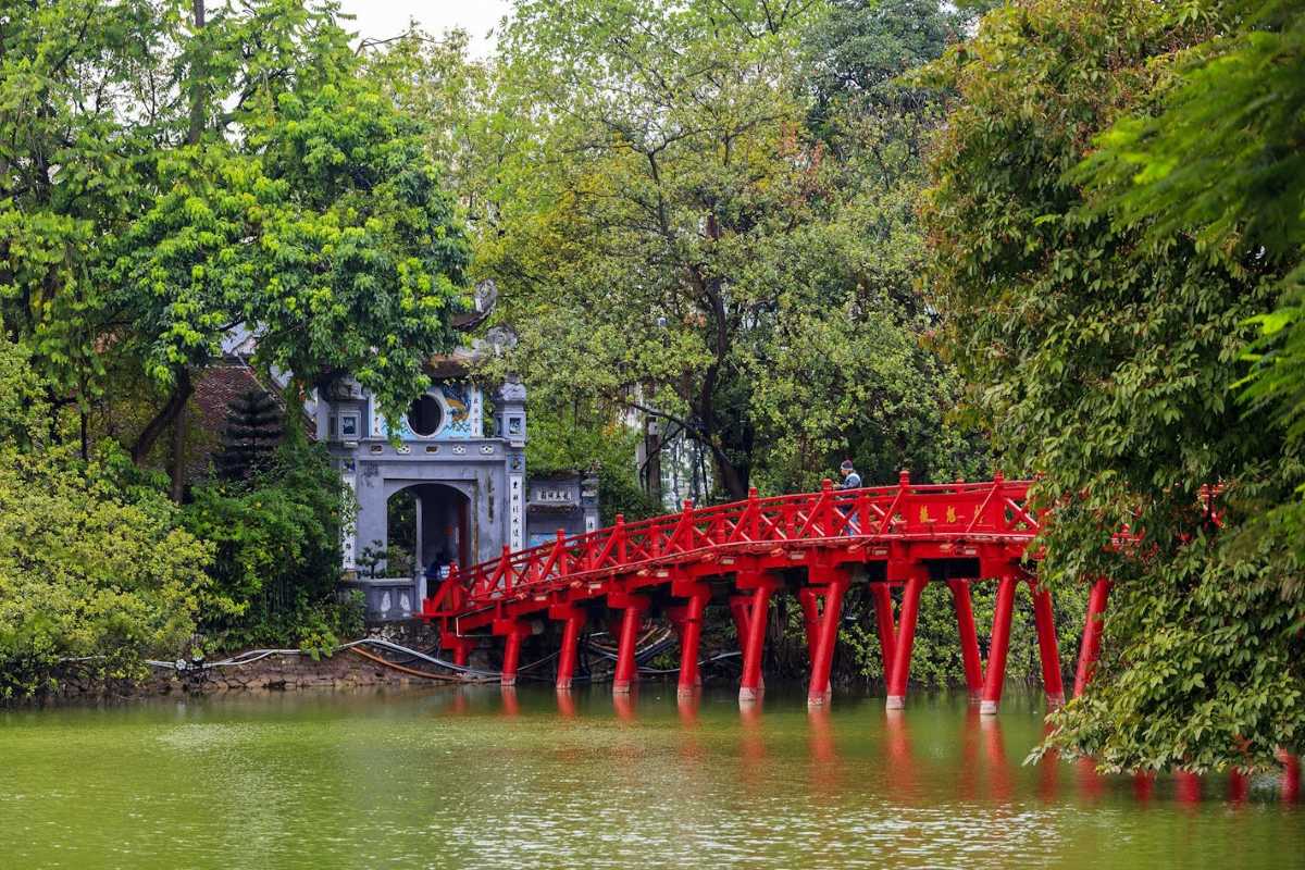 Hoan Kiem Lake Hanoi scenic red wooden bridge The famous red wooden bridge at Hoan Kiem Lake Hanoi, leading to Ngoc Son Temple