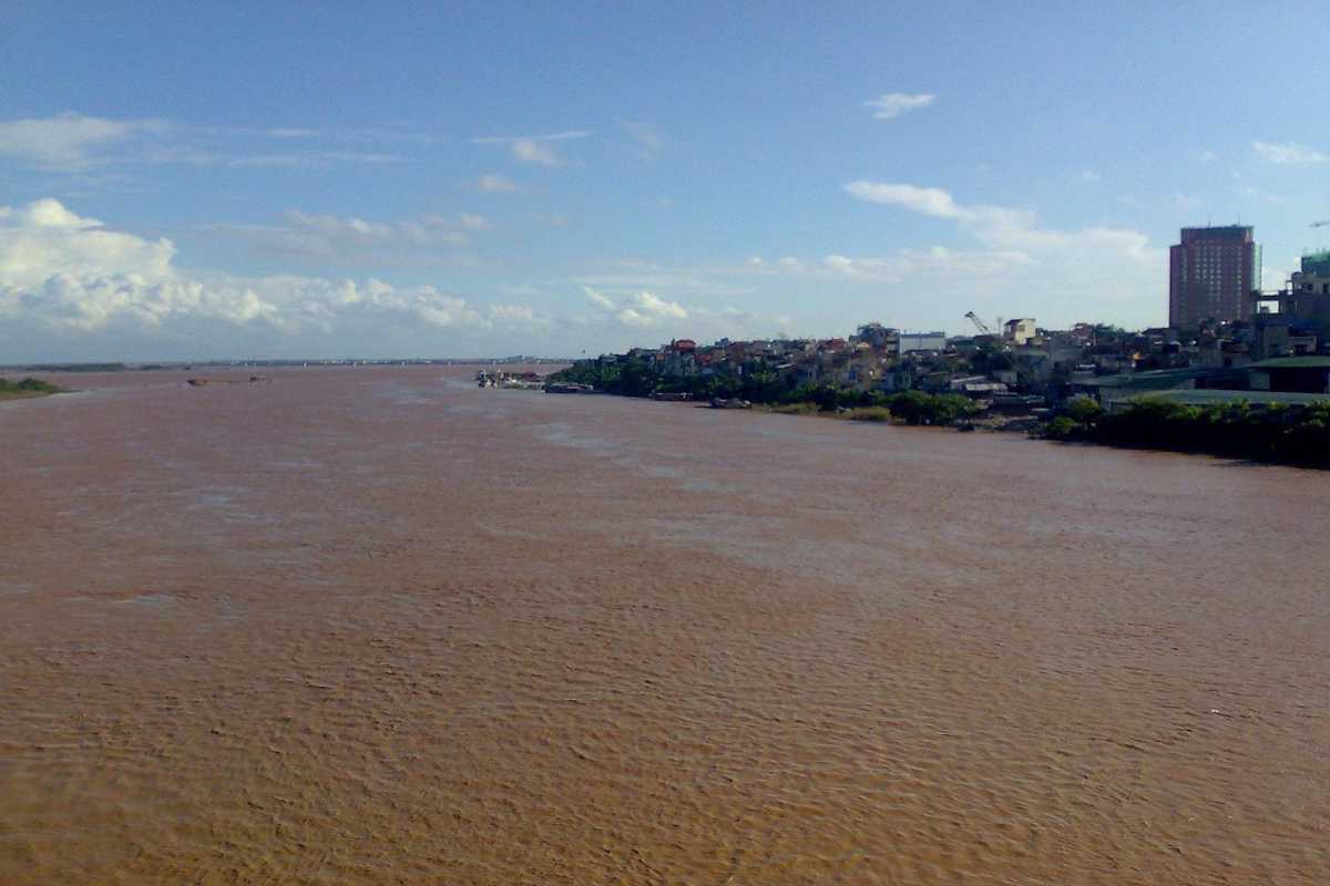 Red River Vietnam Riverside Village with Agricultural Land Riverside village along the Red River Vietnam with farmlands and local homes