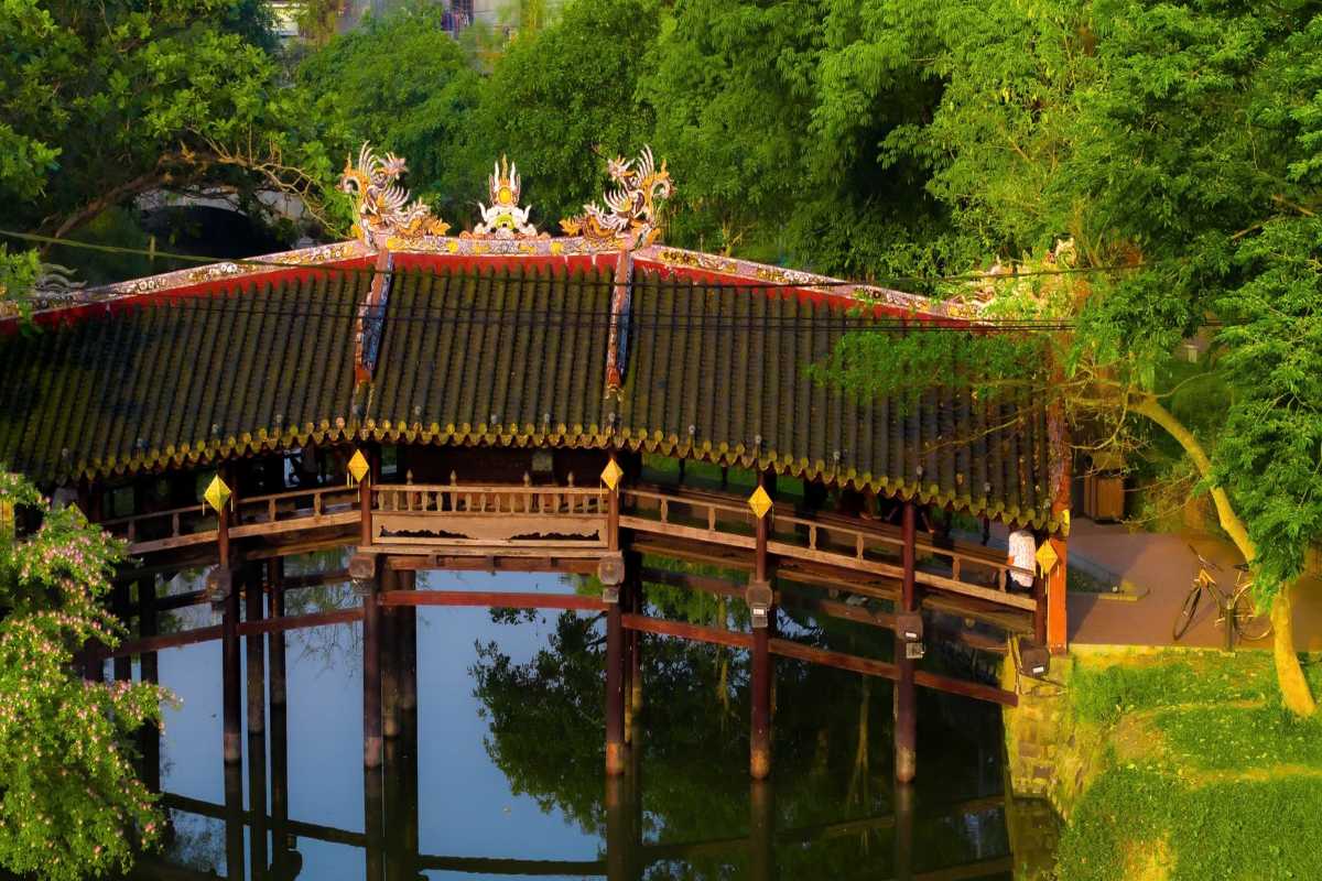 Roof Details of Thanh Toan Bridge with Intricate Design Close-up of the ornamental roof with carvings and traditional Vietnamese design at Thanh Toan Bridge