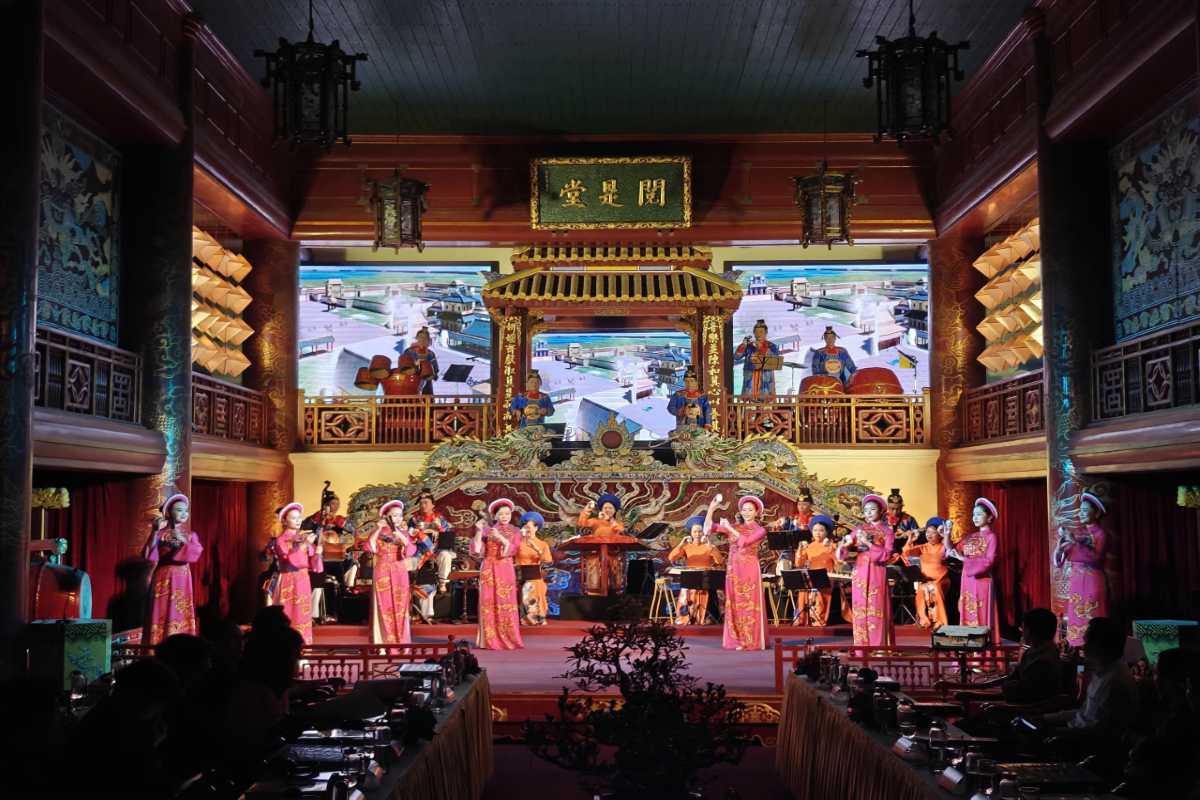 Royal Theatre Hue, Hue, traditional royal music performance Traditional royal musicians and singers perform on stage at Royal Theatre Hue, dressed in vibrant pink costumes.