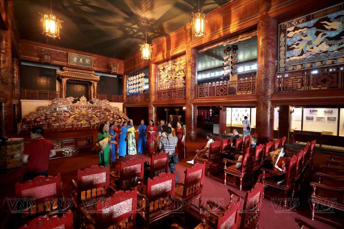 Royal Theatre Hue interior features ornate royal design, wooden seating, and a glimpse of traditional Vietnamese culture.
