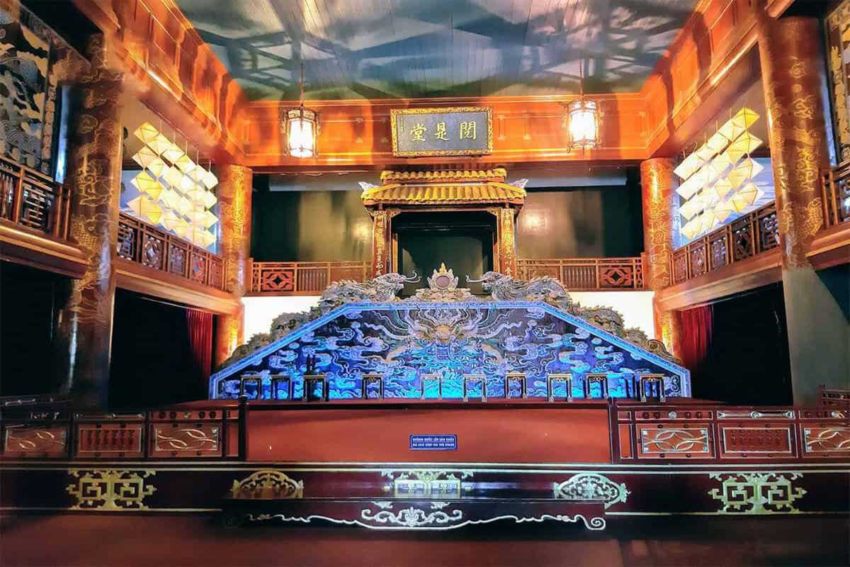 Royal Theatre Hue ornate imperial stage and detailed carvings Royal Theatre Hue showcases its elaborately carved imperial stage, golden dragon motifs, and wooden artistry in a grand performance hall.