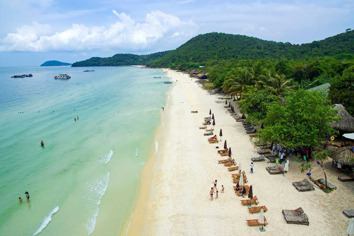 Sao Beach Phu Quoc Lounge Chairs by the Sea Beach lounge chairs under umbrellas along the white sandy beach at Sao Beach Phu Quoc