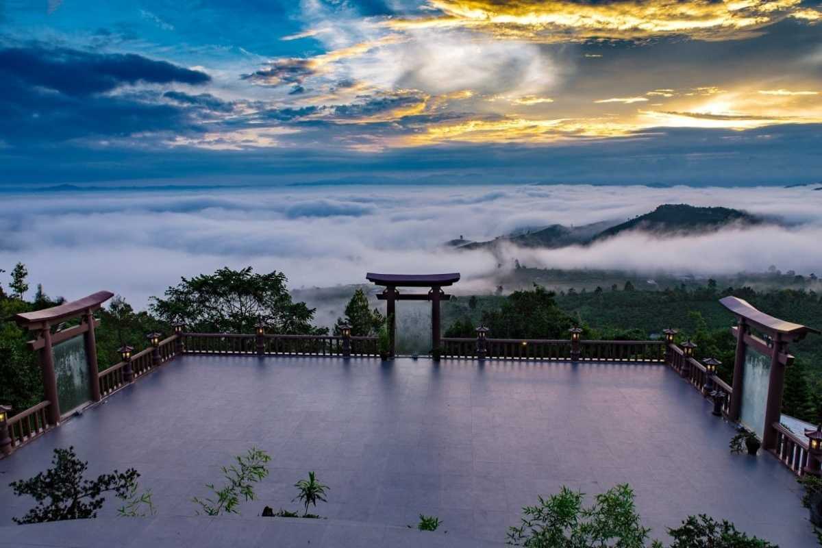 Sapa Heaven Gate sunrise plaza with traditional torii arch Sunrise over Sapa Heaven Gate’s open plaza framed by a torii gate, overlooking a cloud-filled valley