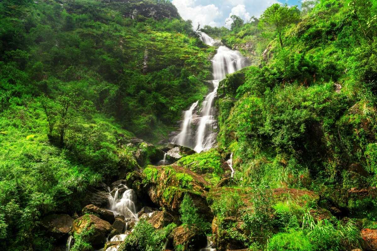 Sapa Love Waterfall upper falls dramatic landscape The dramatic upper tier of Sapa Love Waterfall tumbles down lush green mountains in the heart of Vietnam