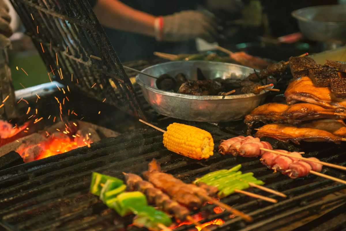Sapa Night Market Grilled Skewers and Local Street Food Close-up of various grilled skewers including vegetables and meats cooking over charcoal at Sapa Night Market.