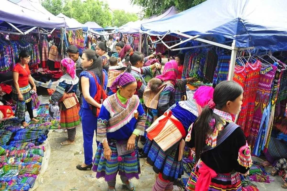 Sapa Night Market Busy Handicraft Stalls Crowded handicraft stalls displaying vibrant ethnic textiles and clothing at Sapa Night Market.