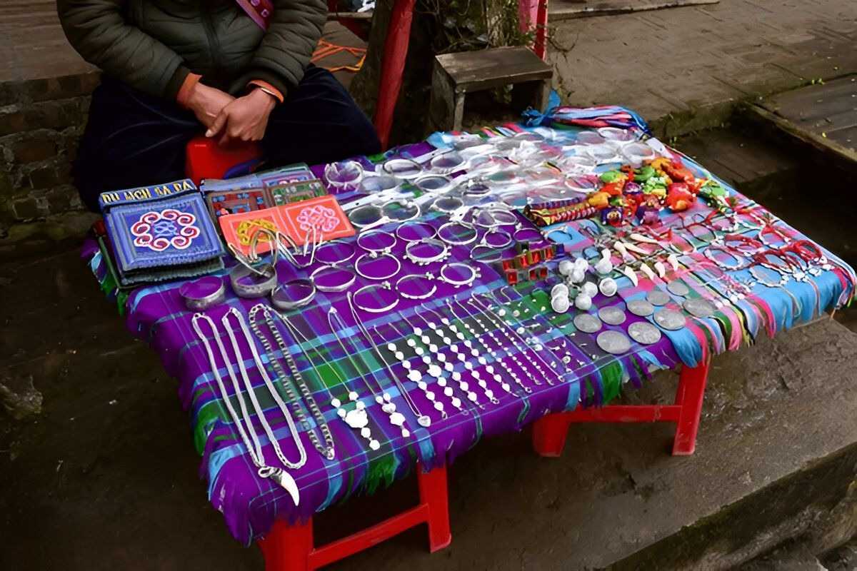 Sapa Night Market Silver Jewelry on Display Table displaying a variety of intricate silver jewelry crafted by local ethnic artisans at Sapa Night Market.