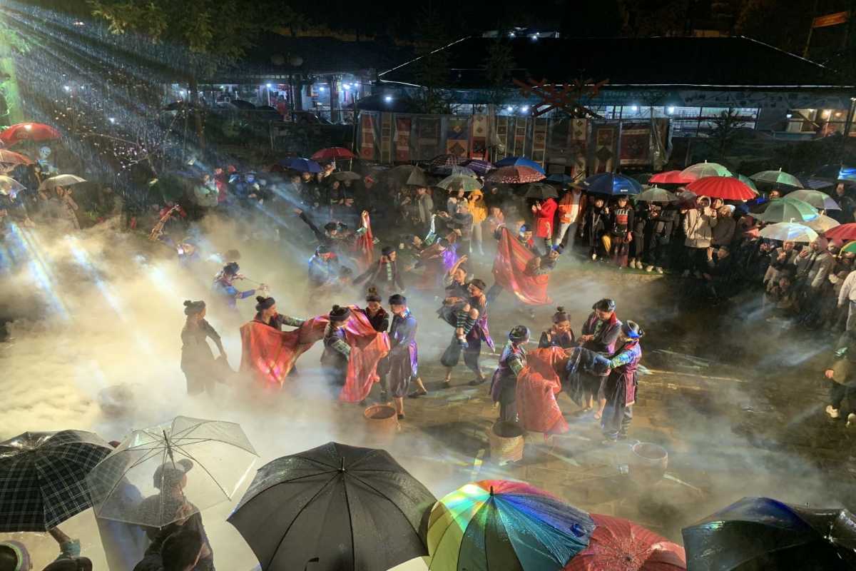 Sapa Night Market Tourists Walking Through Market Street Tourists strolling and exploring the lively Sapa Night Market street with market stalls on both sides.