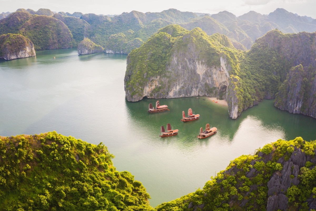 Aerial view of Lan Ha Bay with traditional boats and lush limestone karsts