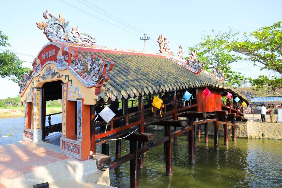 Scenic Path Leading to Thanh Toan Bridge Pathway lined with trees and lanterns leading to the wooden Thanh Toan Bridge