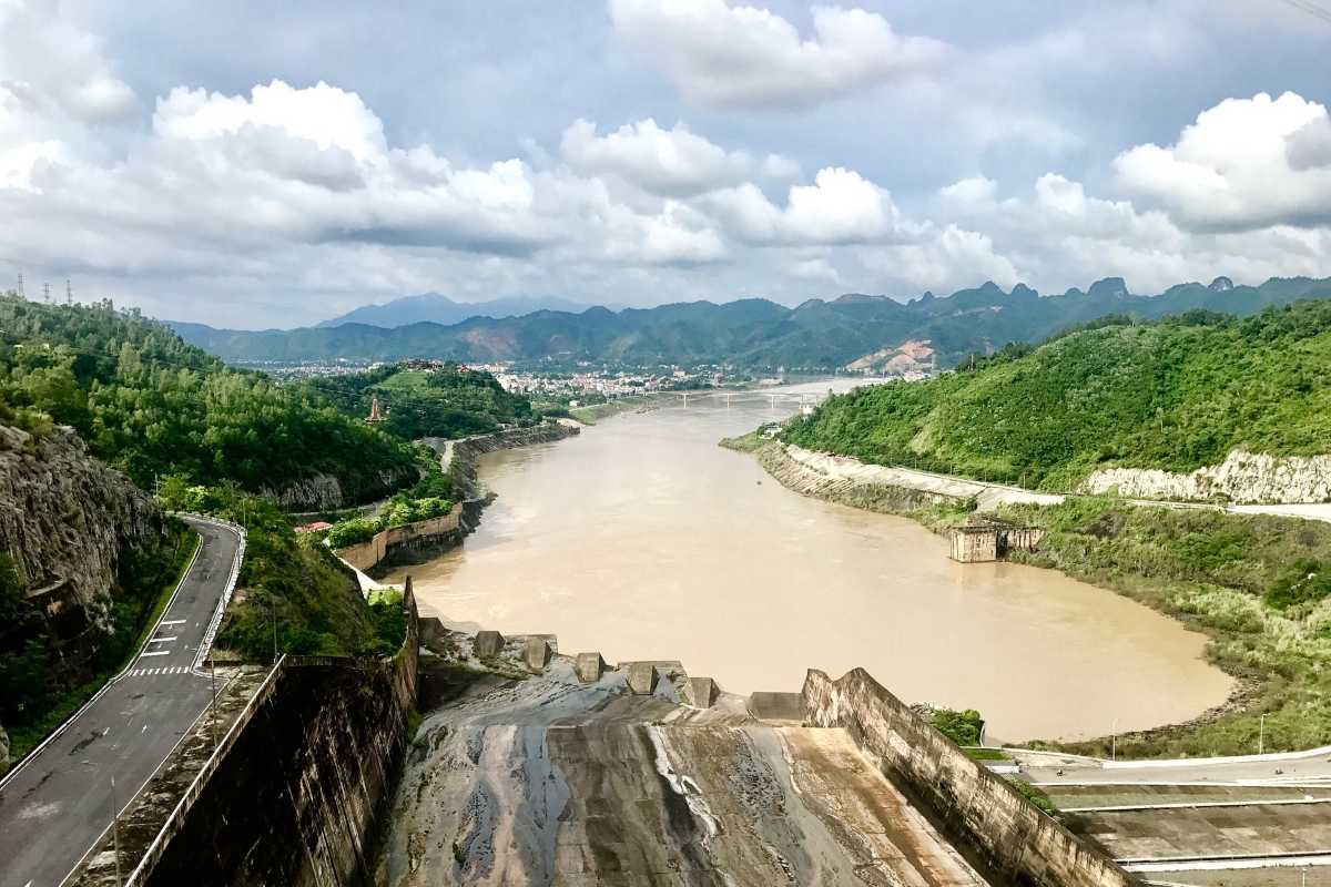 Scenic Red River Vietnam with Urban and Green Spaces Wide view of the Red River Vietnam showing urban buildings and green spaces along the banks