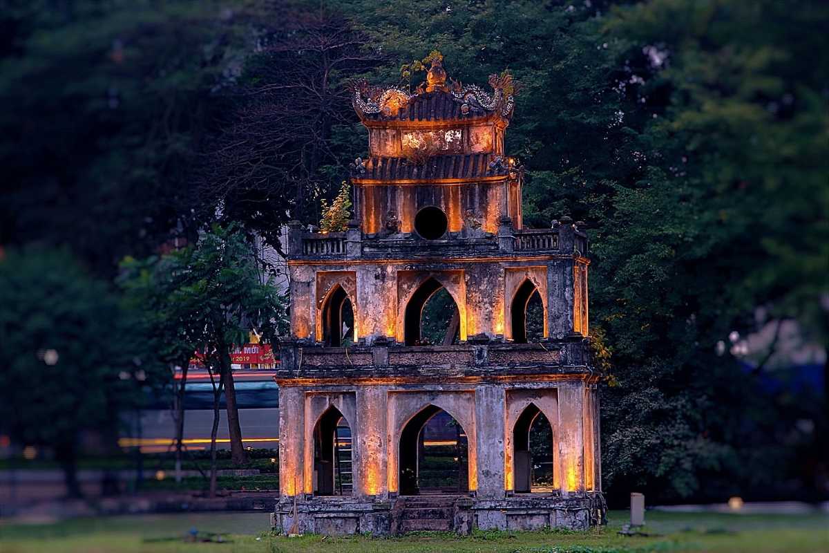 Scenic Turtle Tower Hanoi and Hoan Kiem Lake Scenic view of Turtle Tower Hanoi surrounded by lush greenery and water in Hoan Kiem Lake