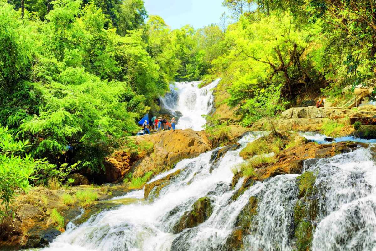 Scenic Waterfall Adventure at Datanla Waterfalls Da Lat Adventurer suspended on ropes descending a waterfall at Datanla Waterfalls in Da Lat