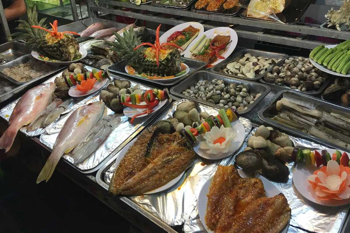 Seafood Selection at Duong Dong Night Market Variety of fresh seafood including fish, shellfish, and vegetables displayed for sale