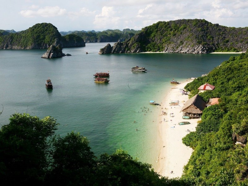 A secluded beach on Cat Ba Island with pristine sand and clear blue waters