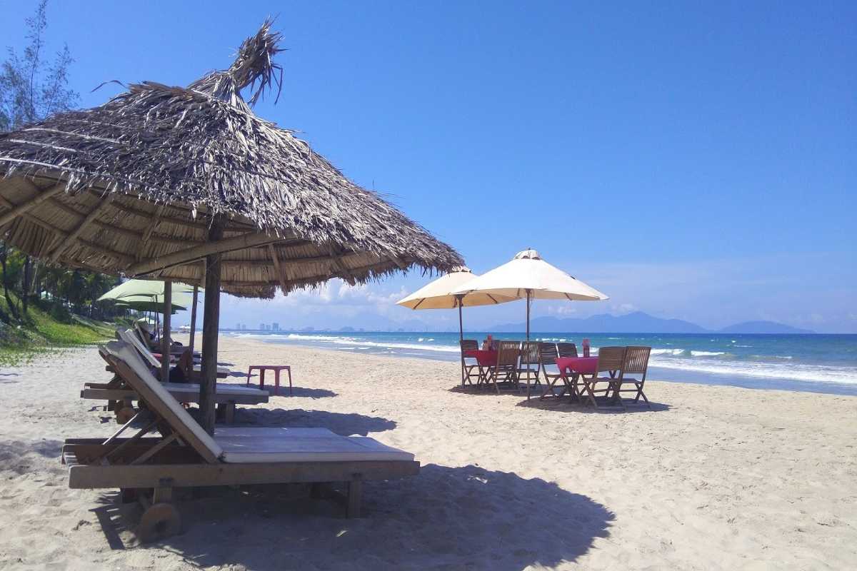 Shade and Tranquility Under Beach Umbrellas at Cua Dai Beach umbrellas providing shade along the sandy stretch of Cua Dai Beach on a sunny day
