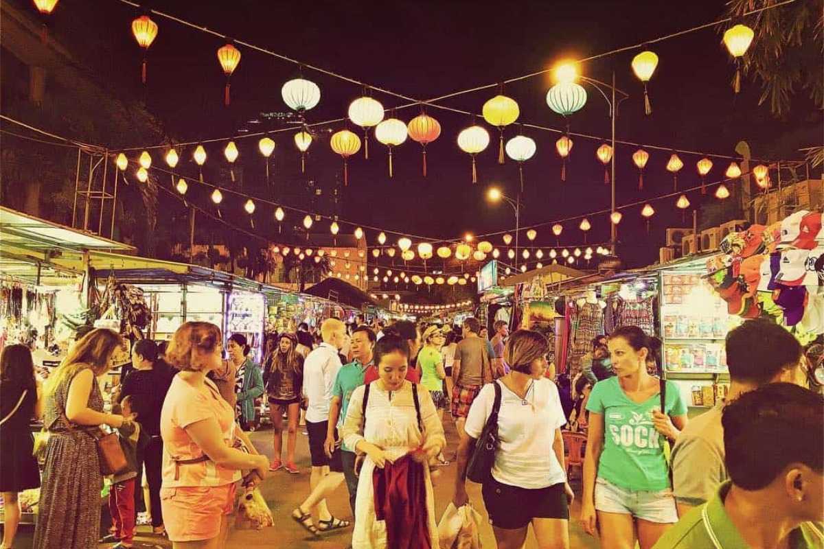 Shoppers at the Nha Trang Night Market People shopping for snacks, clothes, and gifts at Nha Trang Night Market under lanterns