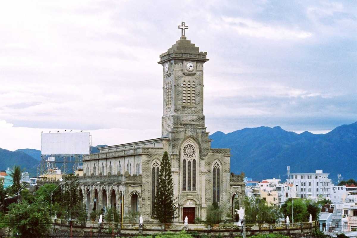 Stone Church Nha Trang Cathedral Side Walkway Side walkway and stone wall of Stone Church Nha Trang Cathedral with trees and clear sky