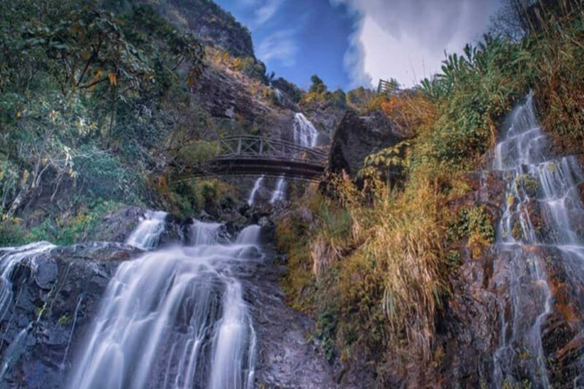 Silver Waterfall Sapa dramatic cascade autumn colors Silver Waterfall Sapa’s cascading streams tumble down rocky slopes framed by vibrant autumn foliage and open skies.