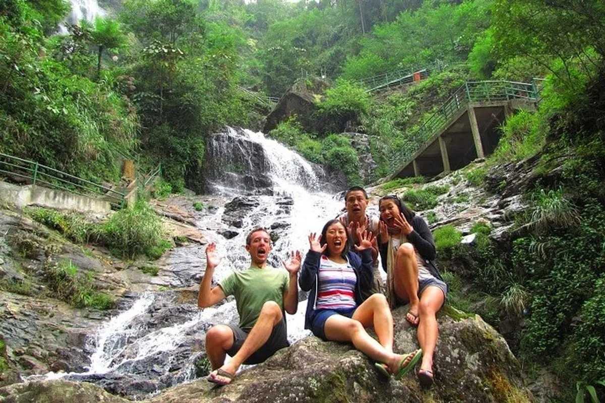 Silver Waterfall Sapa group adventure laughter Silver Waterfall Sapa features a happy group of friends enjoying the rocks and cascades, creating joyful memories.