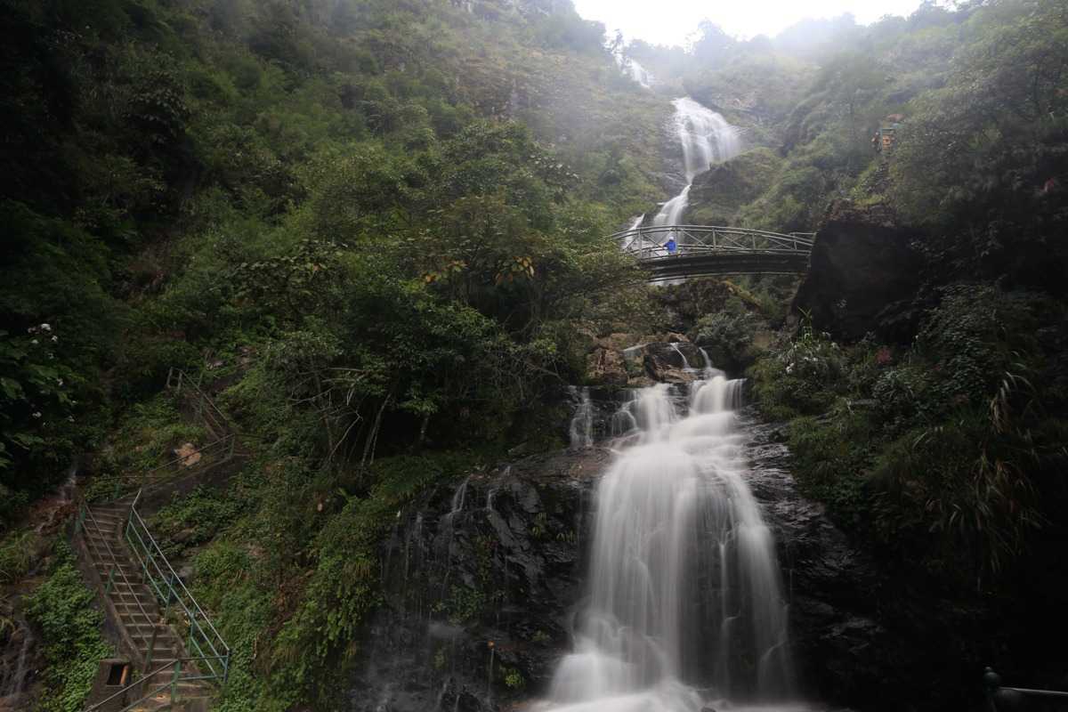 Silver Waterfall Sapa misty morning dramatic falls Silver Waterfall Sapa cascades down mossy rocks on a misty morning, creating a dramatic and enchanting landscape.