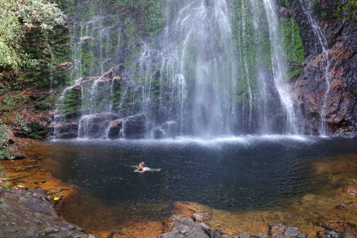 Silver Waterfall Sapa Vietnam tranquil pool under waterfall Silver Waterfall Sapa features a clear natural pool below the cascading falls, surrounded by lush green rocks and moss.