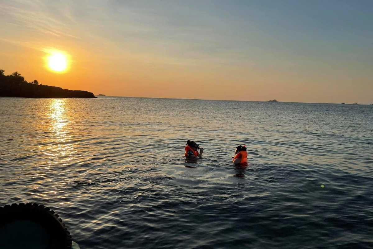Snorkeling Adventure at Ganh Dau Cape Tourists enjoying a snorkeling trip in the clear waters of Ganh Dau Cape near Phu Quoc.