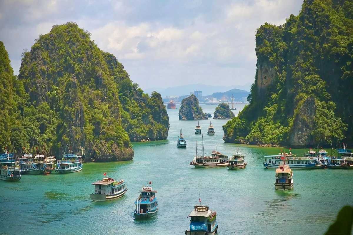 Soi Sim Island Halong Bay beach with tourists enjoying waters Tourists enjoy swimming and relaxing on Soi Sim Island Halong Bay’s beach with clear waters
