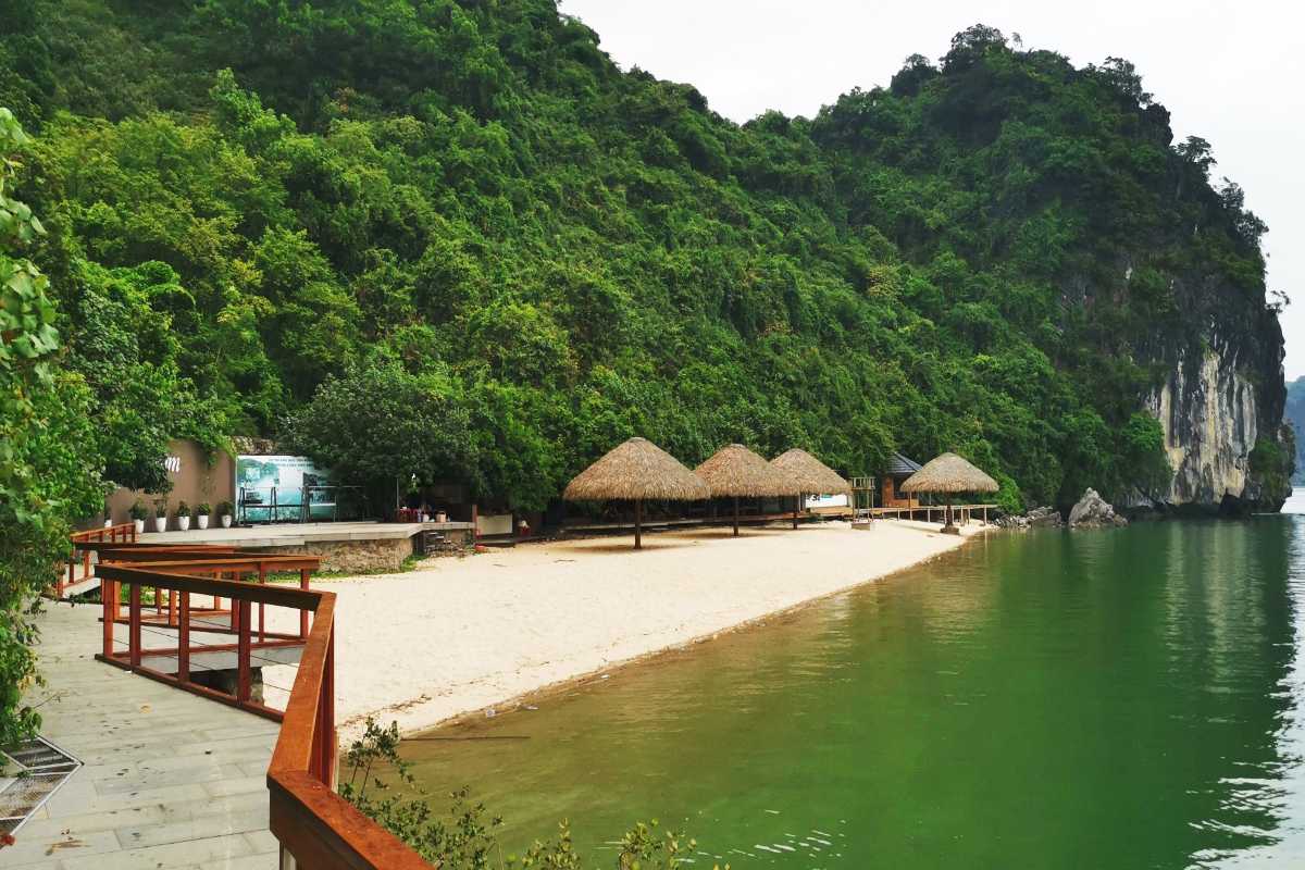 Soi Sim Island Halong Bay beach with tourists and boats Crowded beach on Soi Sim Island Halong Bay with tourists enjoying the shore and boats nearby