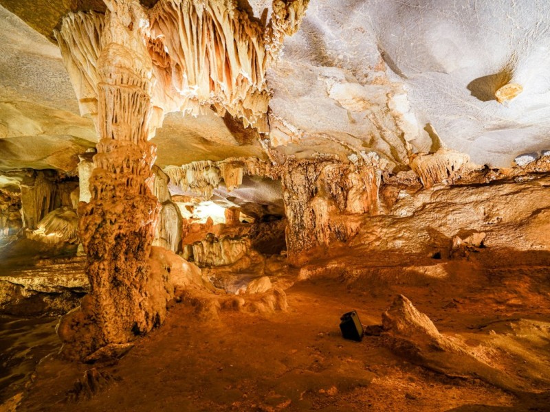 Stalactites and stalagmites inside Thien Canh Son Cave, creating a magical atmosphere.