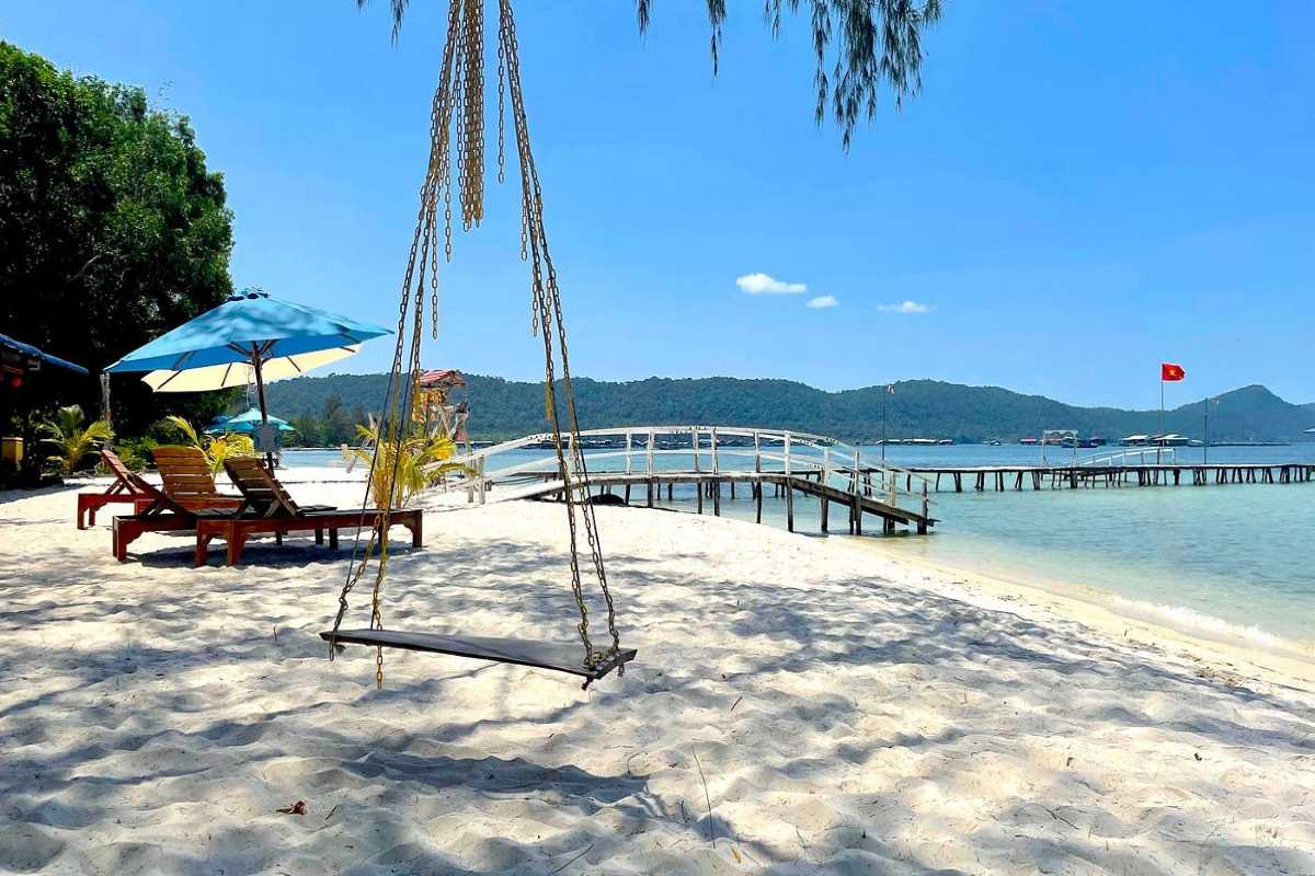 Starfish Beach Phu Quoc shallow water and pier Clear shallow water and long pier at Starfish Beach Phu Quoc with mountains in the background