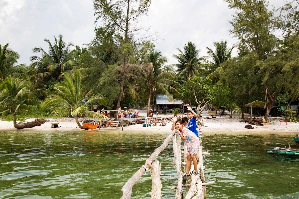 Starfish Beach Phu Quoc turquoise bay and boats Turquoise bay with boats anchored near wooden pier at Starfish Beach Phu Quoc