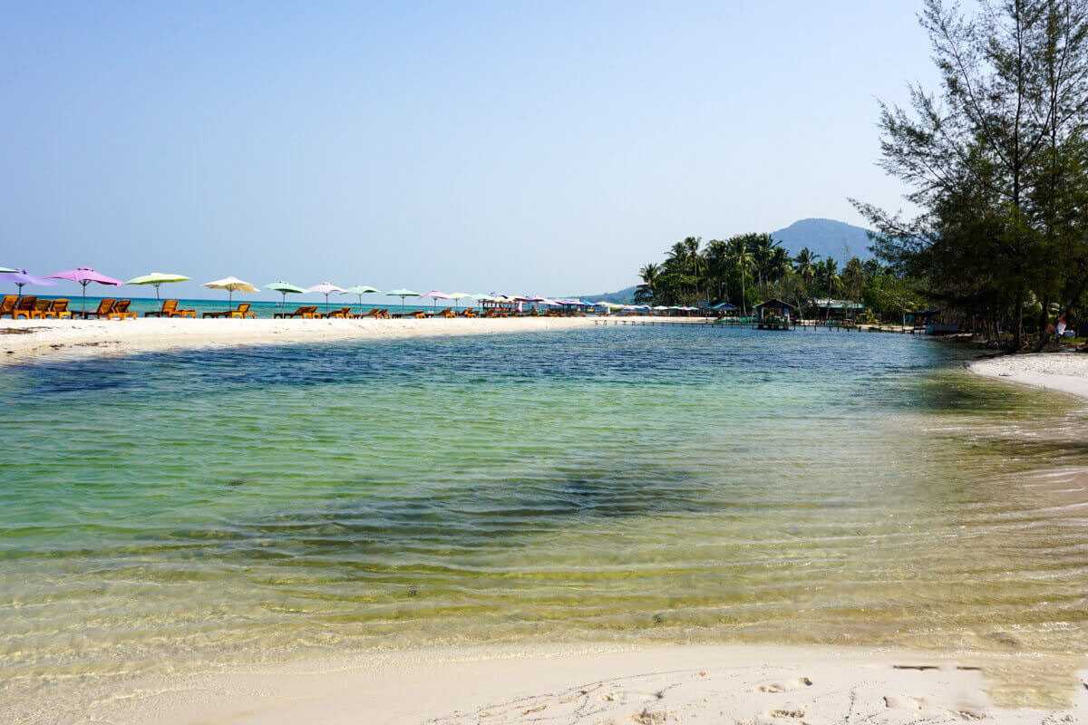 Starfish Beach Phu Quoc woman on wooden jetty Woman sitting on wooden jetty over turquoise water at Starfish Beach Phu Quoc