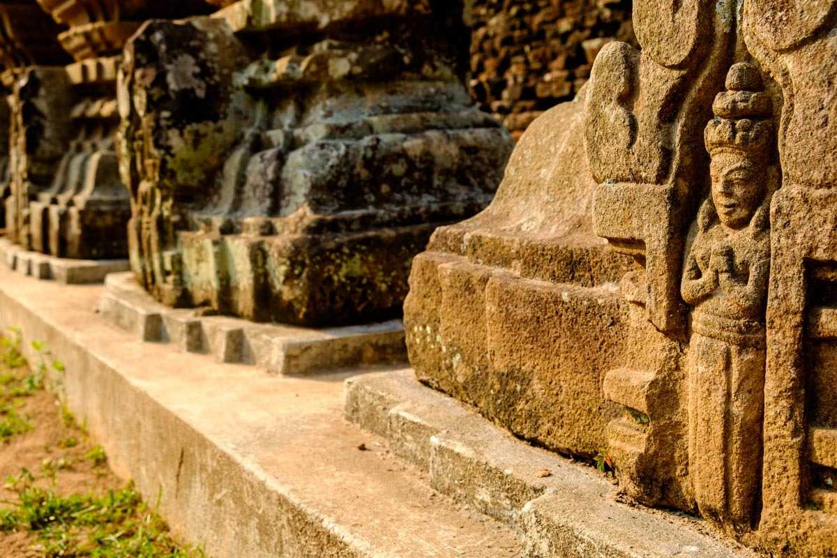 Stone Carved Deities at My Son Sanctuary Stone statues of deities carved into temple walls, part of the spiritual heritage at My Son Sanctuary Vietnam