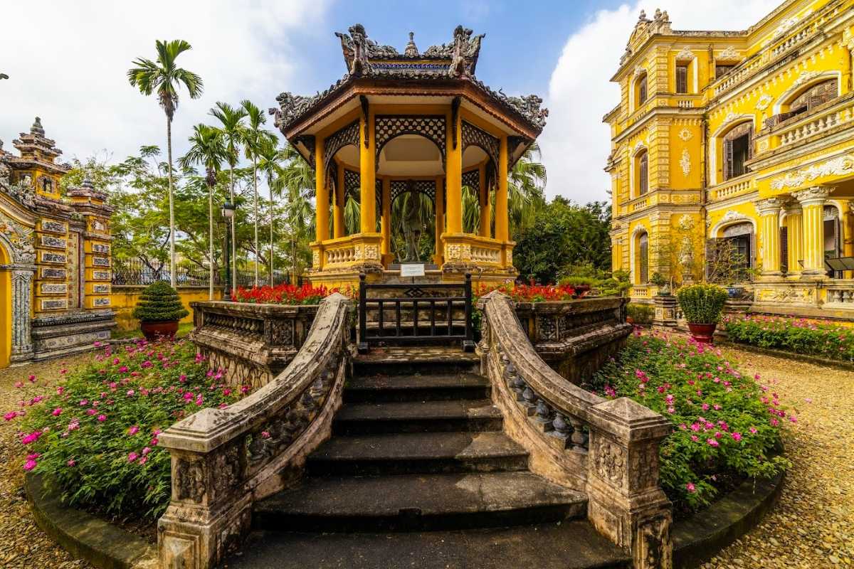 Stone Staircase Leading to An Dinh Palace Stone staircase surrounded by flower beds leading to An Dinh Palace entrance in Hue