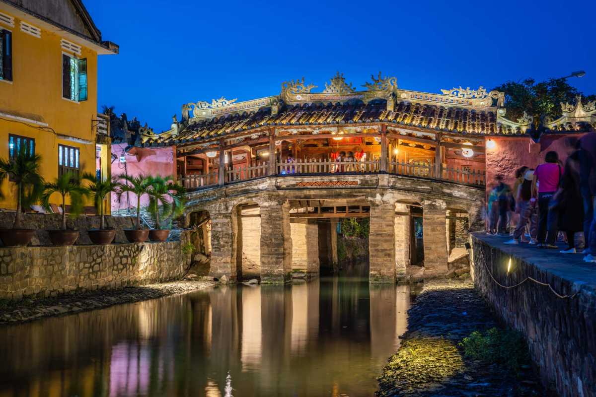 Vibrant street life near the Japanese Bridge Hoi An Crowds and vibrant street life beside the historic Japanese Bridge Hoi An during the day